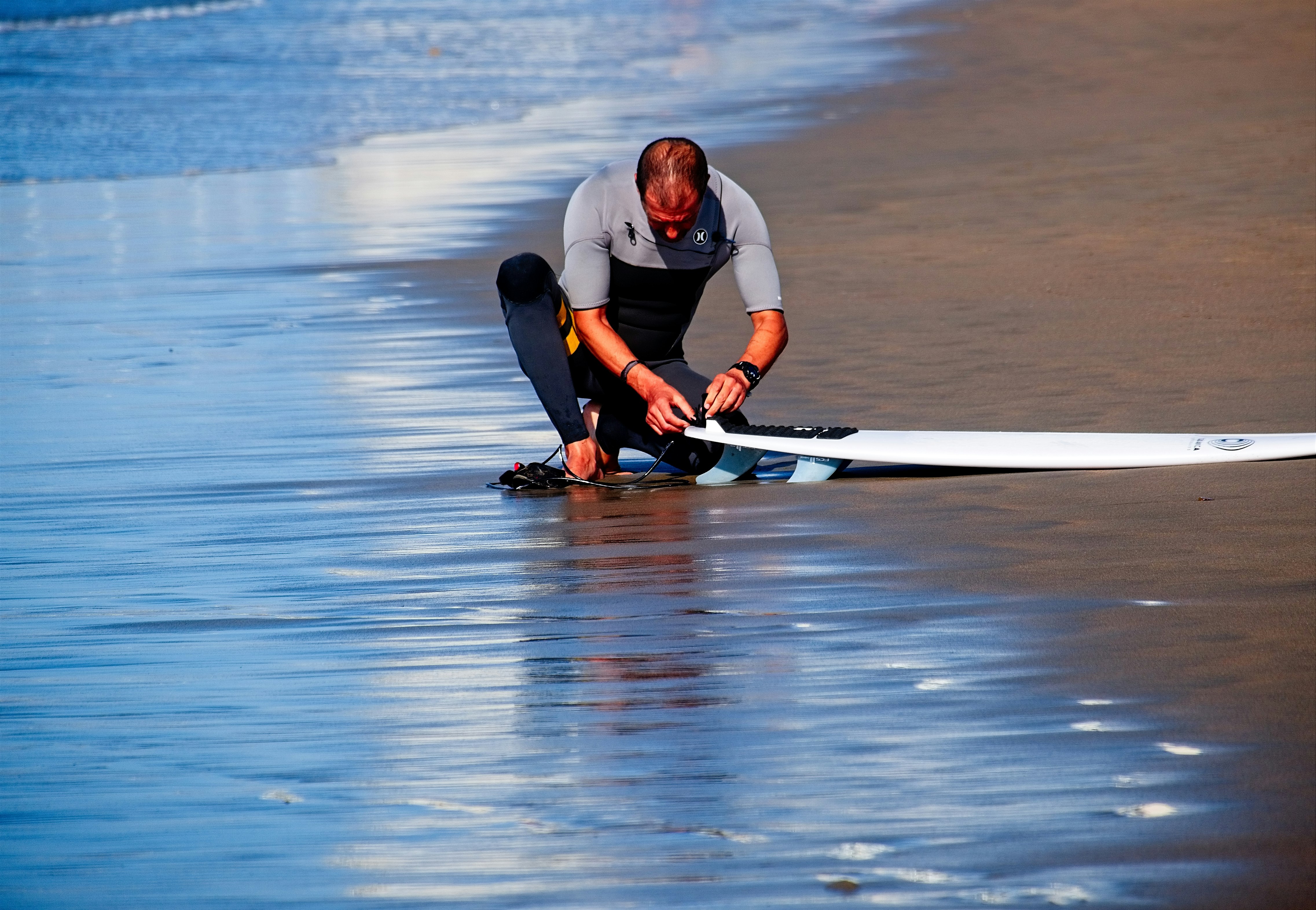 man holding surf board